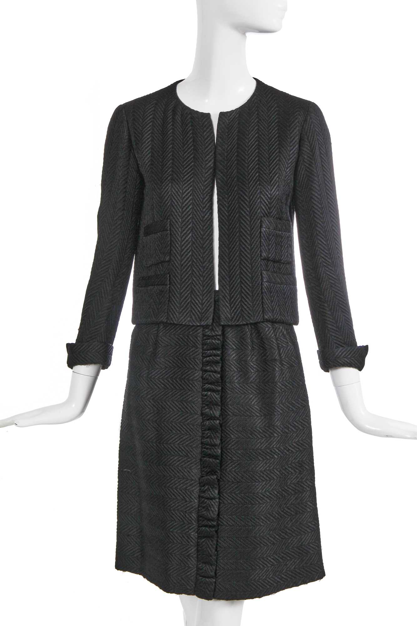 Lot 37 - A Gabrielle Chanel haute couture black herringbone silk suit, circa 1965