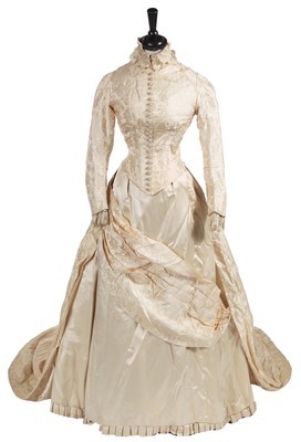Lot 830 - An ivory damask satin bridal gown 1883-5