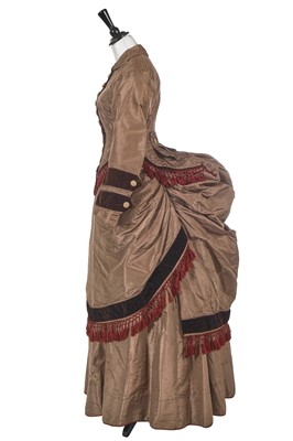 Lot 844 - A pale brown faille and dark brown velvet en tablier gown, 1870-73