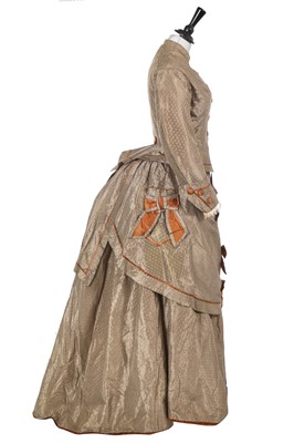 Lot 845 - A figured dove grey silk and copper satin en tablier gown, early 1870s