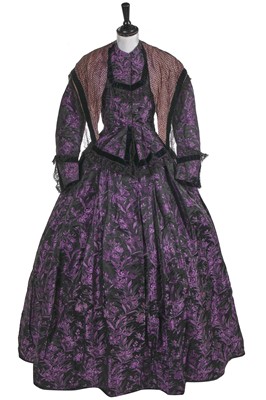 Lot 855 - A woven black and purple satin half mourning gown, late 1850s
