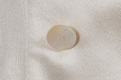 Lot 229 - Two Chanel by Karl Lagerfeld cream silk satin blouses, late 1990s