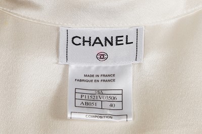 Lot 229 - Two Chanel by Karl Lagerfeld cream silk satin blouses, late 1990s