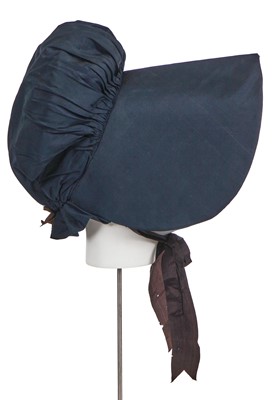 Lot 540 - A navy blue silk bonnet, circa 1830