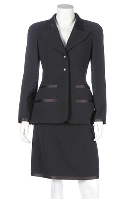 Lot 326 - A Chanel black wool and satin suit, 1997,...