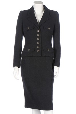 Lot 328 - A Chanel black wool suit, 1990s, boutique...