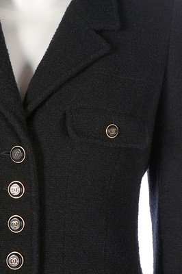 Lot 318 - A Chanel black wool suit, 1990s, boutique...