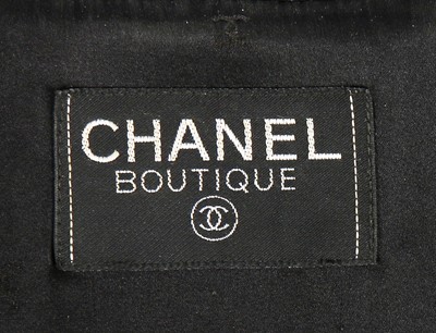 Lot 318 - A Chanel black wool suit, 1990s, boutique...