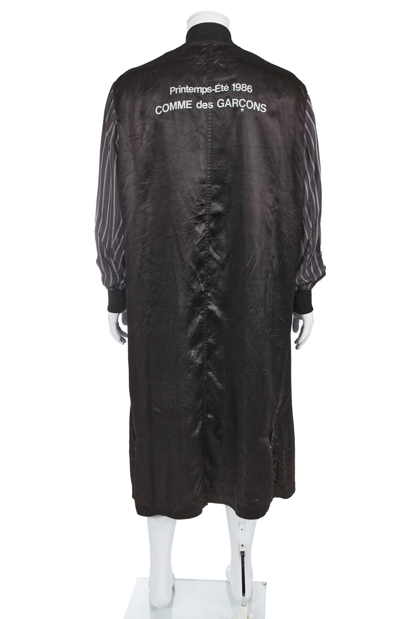Lot 121 - A Comme des Garçons black satin staff coat, Spring-Summer 1986
