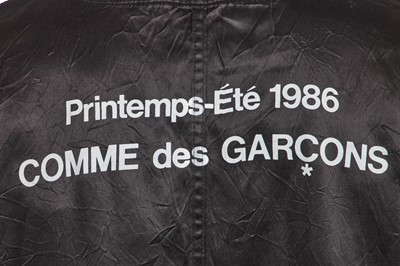 Lot 121 - A Comme des Garçons black satin staff coat, Spring-Summer 1986