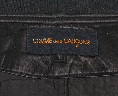 Lot 121 - A Comme des Garçons black satin staff coat, Spring-Summer 1986