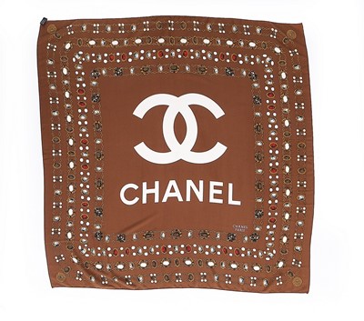 Lot 125 - A Chanel silk scarf printed with sautoirs and...