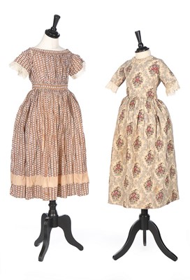 Lot 416 - Three printed cotton girl's dresses, 1830s-60s,...