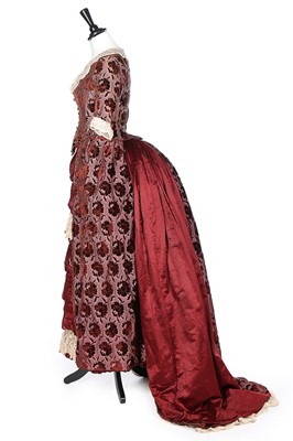 Lot 411 - A burgundy voided velvet and satin evening...