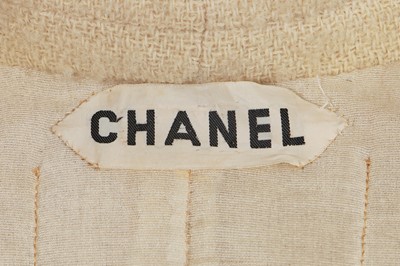 Lot 64 - A Gabrielle Chanel haute couture cream bouclé suit, late 1960s