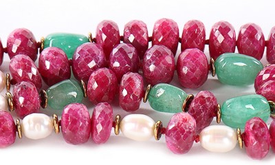 Lot 100 - An Iradj Moini raw emerald, facetted raw ruby...