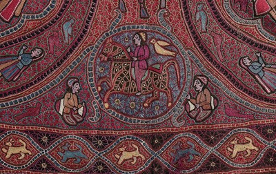 Lot 446 - An embroidered figurative shawl, Indian or...
