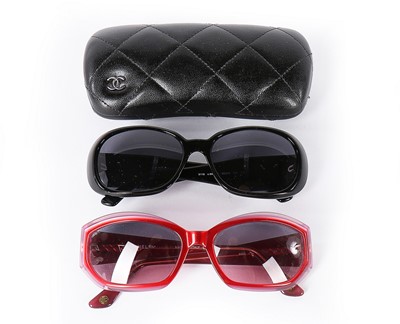 Lot 243 - Two pairs of Chanel sunglasses, 2000s, the...