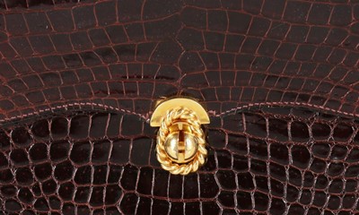 Lot 27 - An Hermès chocolate brown crocodile handbag,...