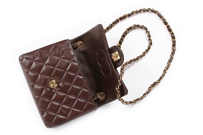 Lot 24 - A Chanel quilted brown leather bag, 1990s,...