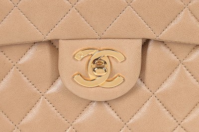 Lot 23 - A Chanel quilted beige leather bag, 1990s,...