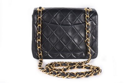 Lot 17 - A Chanel quilted navy leather bag, 1990s,...