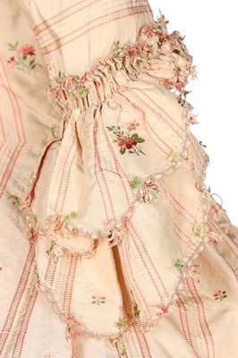 Lot 116 - A striped and floral brocaded pink silk robe à...