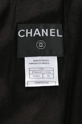 Lot 77 - A Chanel black bouclé wool ensemble, 2007,...