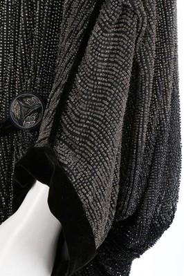 Lot 176 - A Paul Poiret ombré-effect beaded opera coat,...