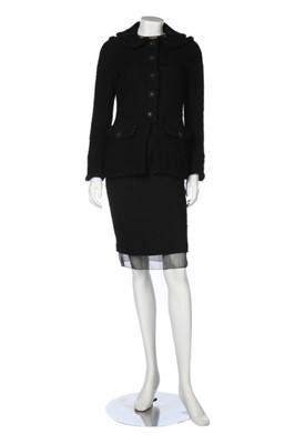 Lot 132 - A Chanel black bouclé wool dress and jacket...