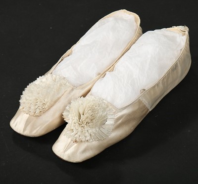 Lot 245 - Two pairs of ivory satin pumps, the first...