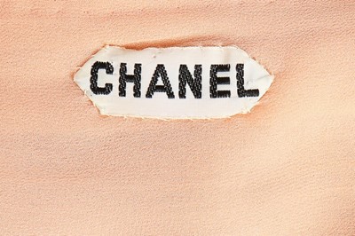 Lot 204 - A Chanel couture beaded pale peach chiffon...