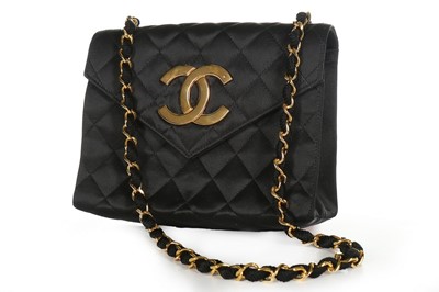 Lot 121 - A Chanel black satin quilted evening bag with...