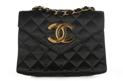 Lot 121 - A Chanel black satin quilted evening bag with...