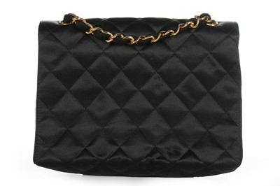 Lot 121 - A Chanel black satin quilted evening bag with...