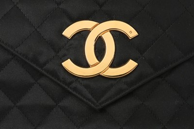 Lot 121 - A Chanel black satin quilted evening bag with...