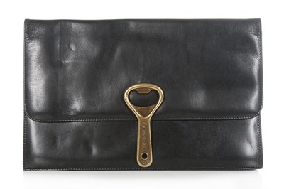 Lot 124 - A Moschino black leather clutch bag with 'can...