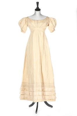 Lot 250 - An ivory silk evening dress, circa 1820,...