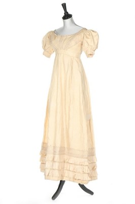 Lot 250 - An ivory silk evening dress, circa 1820,...