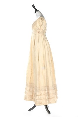 Lot 250 - An ivory silk evening dress, circa 1820,...