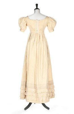 Lot 250 - An ivory silk evening dress, circa 1820,...