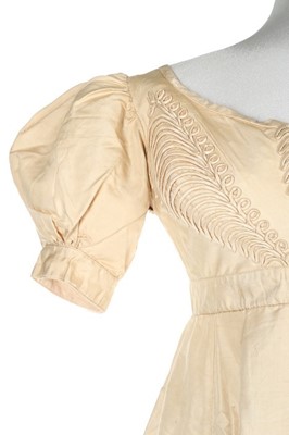 Lot 250 - An ivory silk evening dress, circa 1820,...