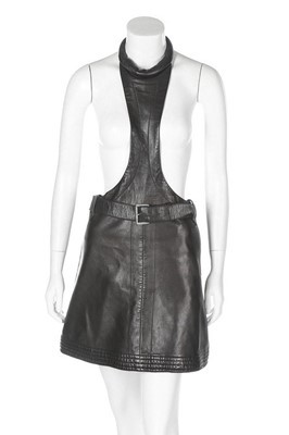Lot 170 - A Pierre Cardin black leather pinafore, 1967,...