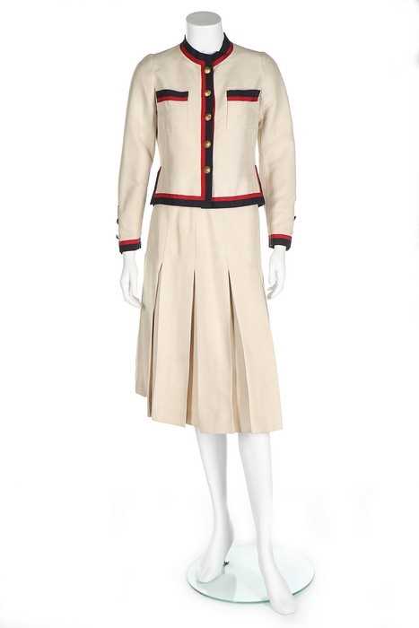 Lot 199 - A Chanel couture ivory silk suit with...