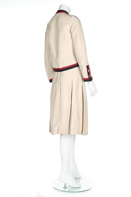 Lot 199 - A Chanel couture ivory silk suit with...