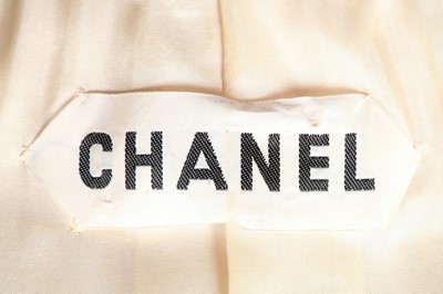 Lot 199 - A Chanel couture ivory silk suit with...