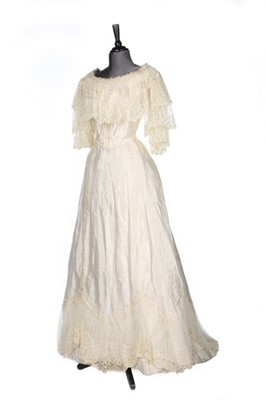 Lot 263 - An ivory silk ball gown, circa 1900, worn by...