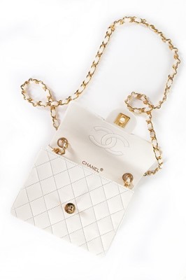 Lot 5 - A Chanel quilted white leather bag, 1990s,...