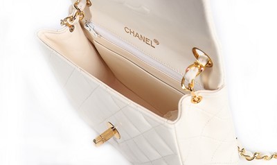 Lot 5 - A Chanel quilted white leather bag, 1990s,...