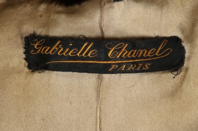 Lot 58 - A rare and early Gabrielle Chanel black satin...
